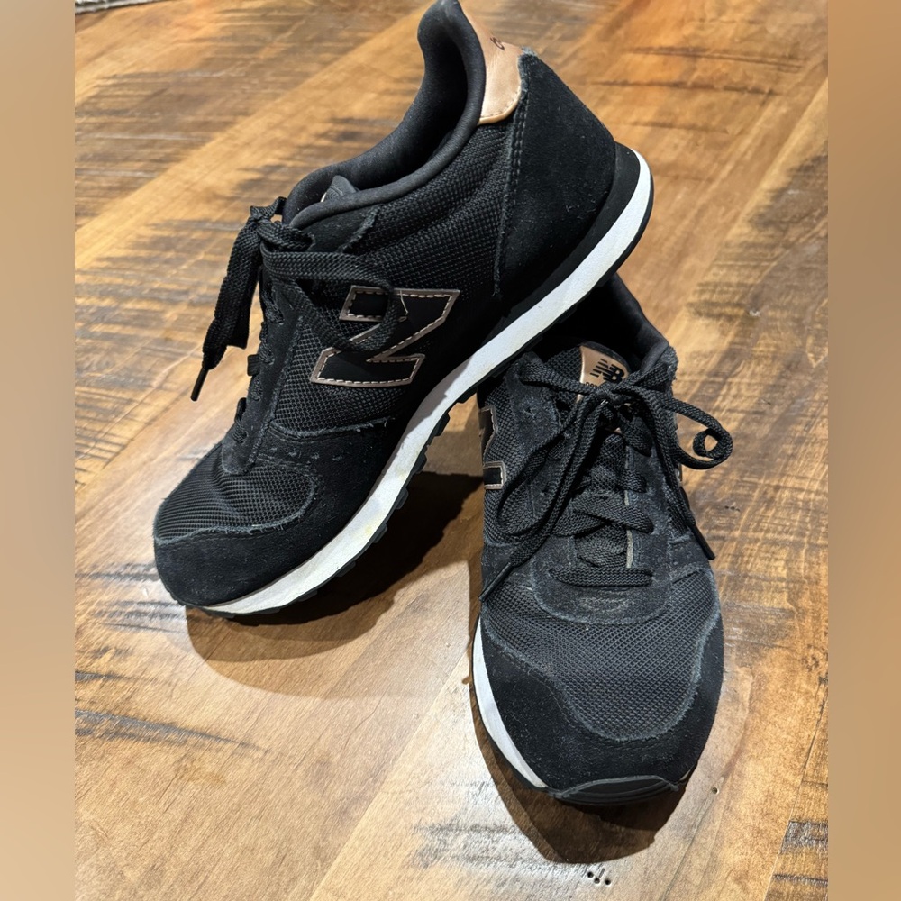 New Balance Black and Gold 311 women’s sneakers